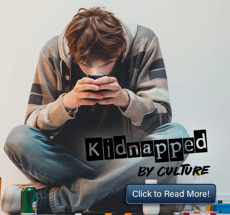 Teen sitting on floor immersed in his phone