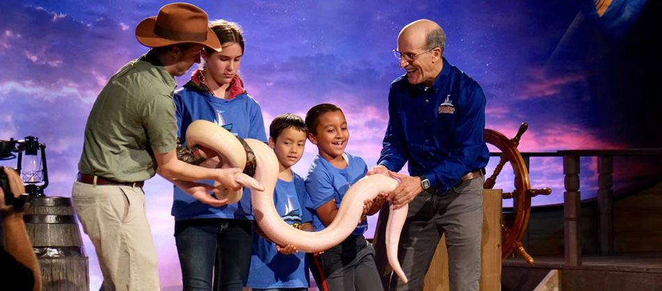 Pastor Doug Batchelor and Amazing Adventure kids holding a snake