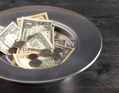 Offering plate with money